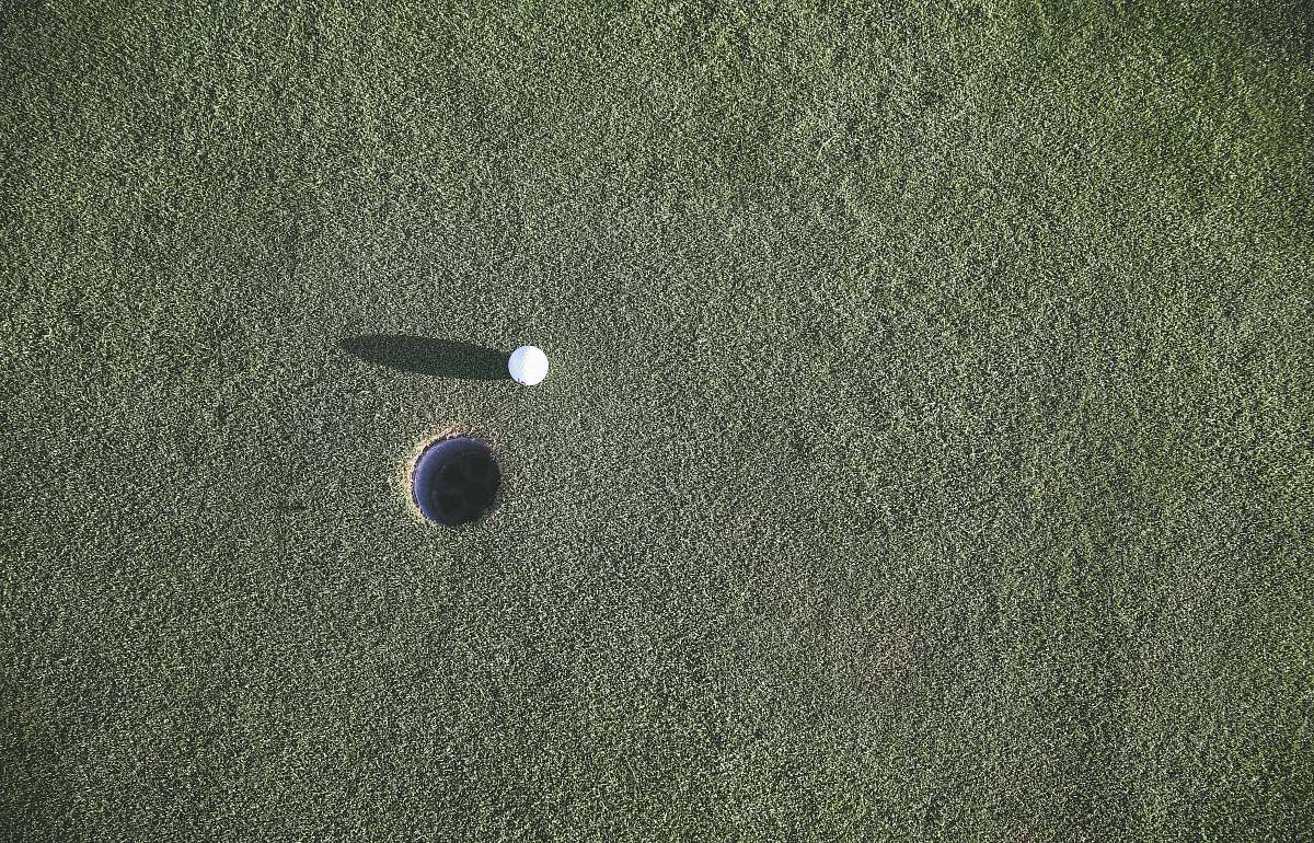 ball white golf ball near hole sport